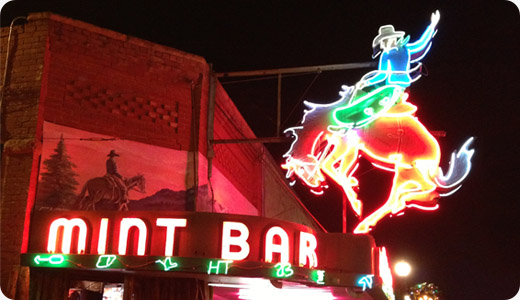 Neon cowboy sign outside of Mint Bar in Sheridan, Wyoming